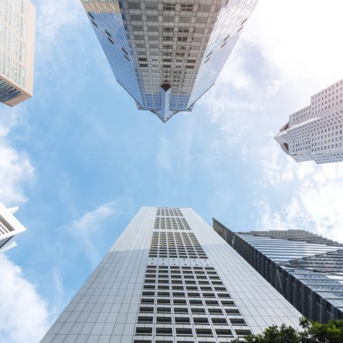 Exterior of modern high building in business city center with blue sky. Picture for add text message. Backdrop for design art work.